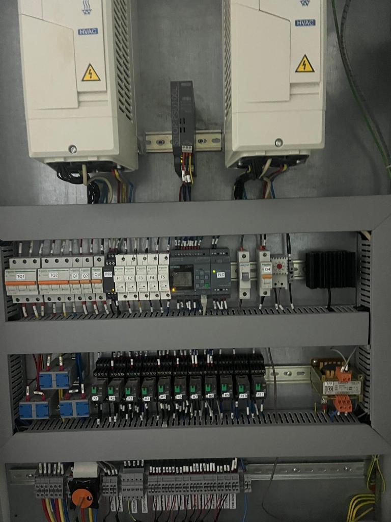 Variable-frequency drives, a Siemens LOGO PLC and Schneider breakers in a finished HVAC panel.